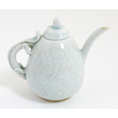 7 - A small Chinese teapot with scrolling detail. Approx. 4 1/2