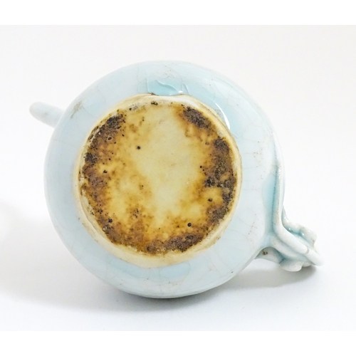 7 - A small Chinese teapot with scrolling detail. Approx. 4 1/2