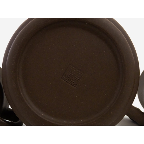 17 - A Chinese Yixing style tea set comprising teapot, four cups and a circular tray / dish. Impressed Ch... 