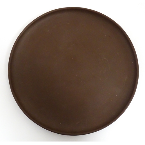 17 - A Chinese Yixing style tea set comprising teapot, four cups and a circular tray / dish. Impressed Ch... 