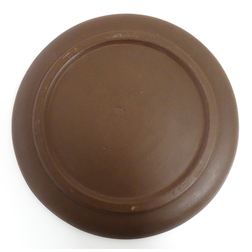 17 - A Chinese Yixing style tea set comprising teapot, four cups and a circular tray / dish. Impressed Ch... 