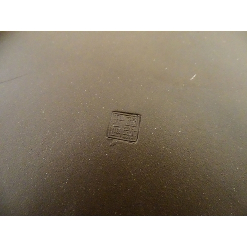 17 - A Chinese Yixing style tea set comprising teapot, four cups and a circular tray / dish. Impressed Ch... 