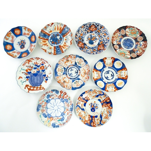 64 - Nine assorted Japanese plates / dishes decorated in the Imari palette with flowers, foliage, etc. La... 