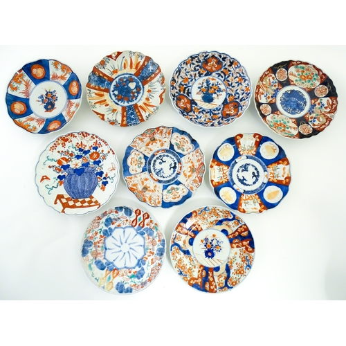 64 - Nine assorted Japanese plates / dishes decorated in the Imari palette with flowers, foliage, etc. La... 