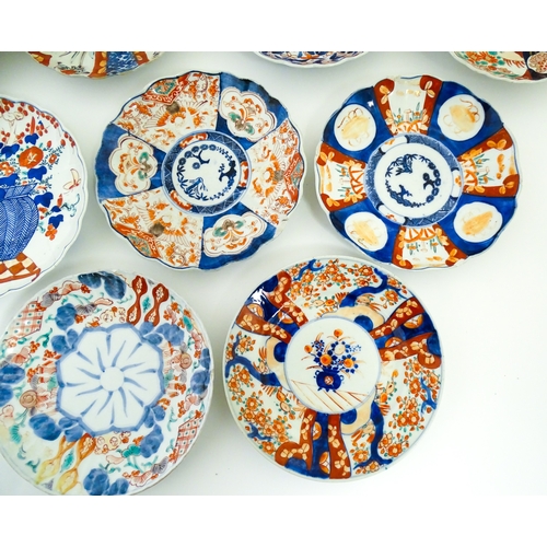 64 - Nine assorted Japanese plates / dishes decorated in the Imari palette with flowers, foliage, etc. La... 