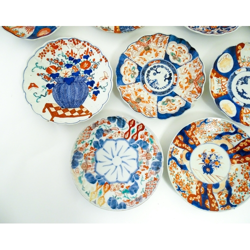 64 - Nine assorted Japanese plates / dishes decorated in the Imari palette with flowers, foliage, etc. La... 