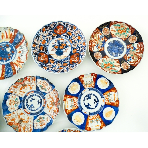 64 - Nine assorted Japanese plates / dishes decorated in the Imari palette with flowers, foliage, etc. La... 