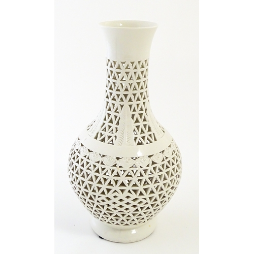 66 - A Chinese vase with reticulated decoration and banded leaf motifs. Approx. 14 3/4