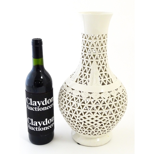 66 - A Chinese vase with reticulated decoration and banded leaf motifs. Approx. 14 3/4