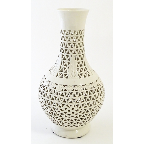 66 - A Chinese vase with reticulated decoration and banded leaf motifs. Approx. 14 3/4