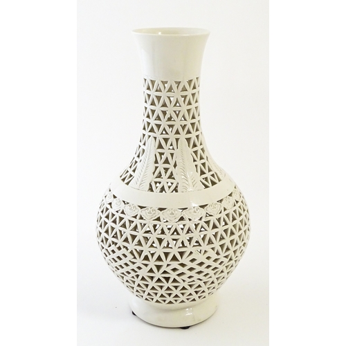 66 - A Chinese vase with reticulated decoration and banded leaf motifs. Approx. 14 3/4