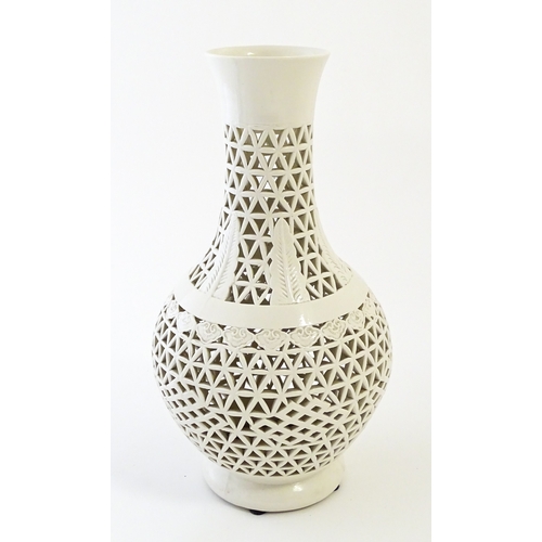 66 - A Chinese vase with reticulated decoration and banded leaf motifs. Approx. 14 3/4