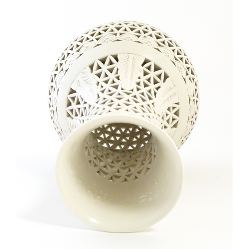 66 - A Chinese vase with reticulated decoration and banded leaf motifs. Approx. 14 3/4