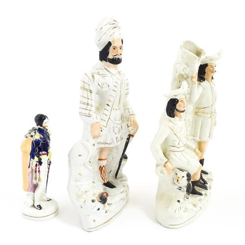 68 - Three Staffordshire pottery figures comprising The Lion Slayer, a spill vase titled Robin Hood, and ... 