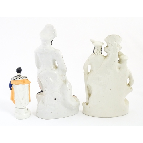 68 - Three Staffordshire pottery figures comprising The Lion Slayer, a spill vase titled Robin Hood, and ... 