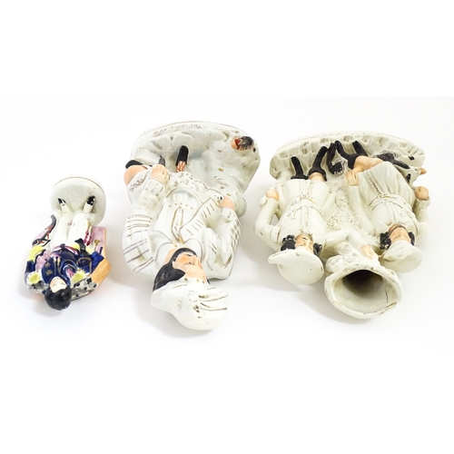 68 - Three Staffordshire pottery figures comprising The Lion Slayer, a spill vase titled Robin Hood, and ... 