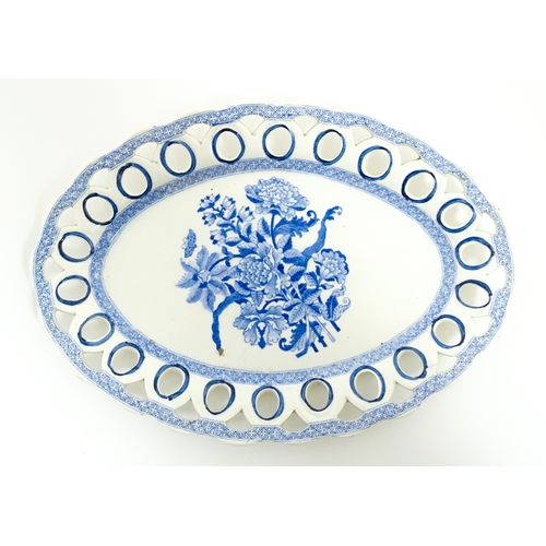 75 - A blue and white chestnut basket and stand with pierced decoration and floral detail. Possibly Spode... 