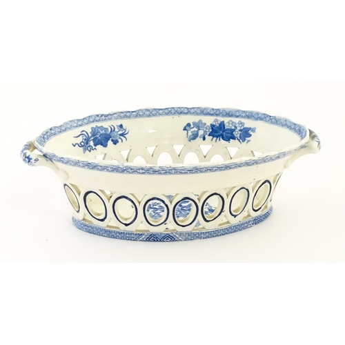 75 - A blue and white chestnut basket and stand with pierced decoration and floral detail. Possibly Spode... 