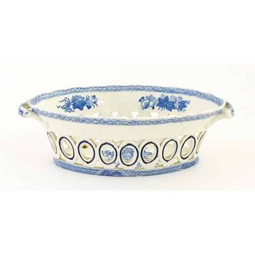 75 - A blue and white chestnut basket and stand with pierced decoration and floral detail. Possibly Spode... 