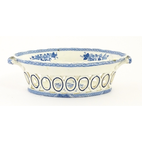 75 - A blue and white chestnut basket and stand with pierced decoration and floral detail. Possibly Spode... 