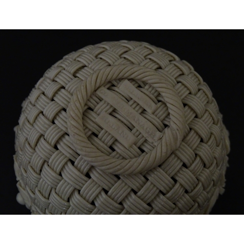 79 - Three Belleek baskets to include a three strand example of shamrock form, a round basket with applie... 