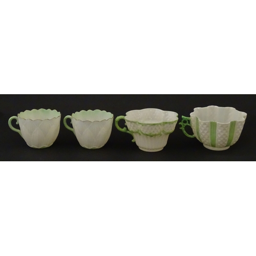 82 - Two Belleek Lily pattern cups and saucers with green highlights. Together with a Belleek 5 O'Clock p... 