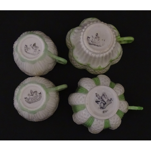 82 - Two Belleek Lily pattern cups and saucers with green highlights. Together with a Belleek 5 O'Clock p... 