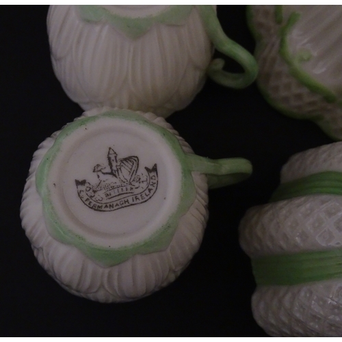 82 - Two Belleek Lily pattern cups and saucers with green highlights. Together with a Belleek 5 O'Clock p... 