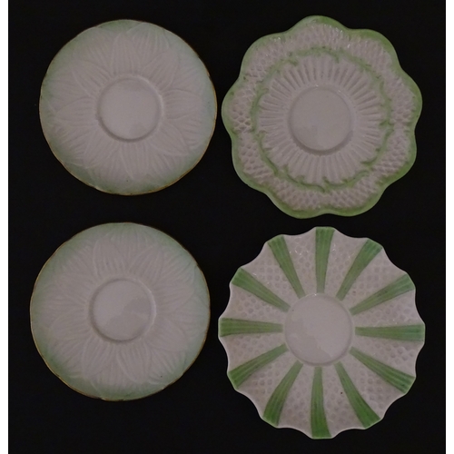 82 - Two Belleek Lily pattern cups and saucers with green highlights. Together with a Belleek 5 O'Clock p... 