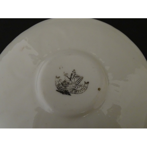 82 - Two Belleek Lily pattern cups and saucers with green highlights. Together with a Belleek 5 O'Clock p... 