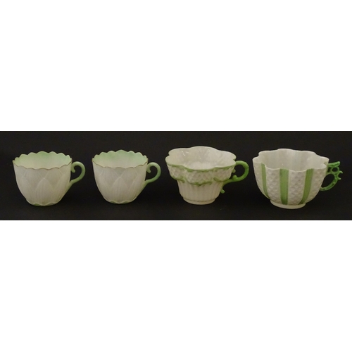 82 - Two Belleek Lily pattern cups and saucers with green highlights. Together with a Belleek 5 O'Clock p... 