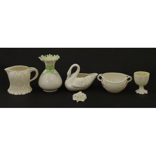 83 - Six assorted Belleek items comprising a cream jug in the Ampanida pattern, a small vase with bow det... 