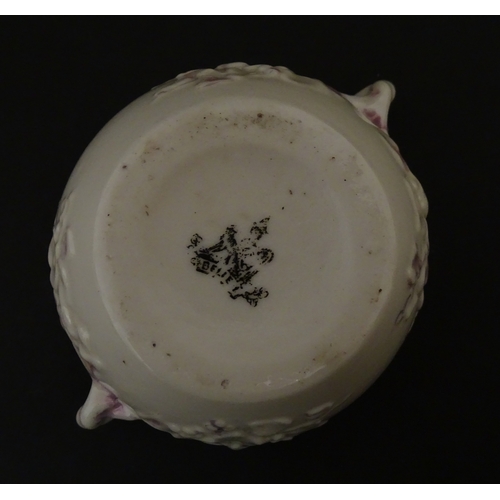 83 - Six assorted Belleek items comprising a cream jug in the Ampanida pattern, a small vase with bow det... 