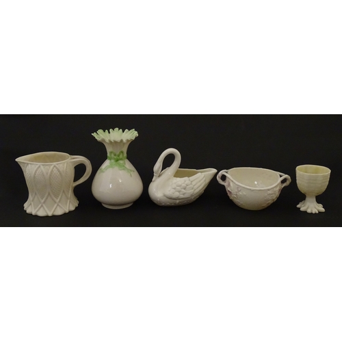 83 - Six assorted Belleek items comprising a cream jug in the Ampanida pattern, a small vase with bow det... 