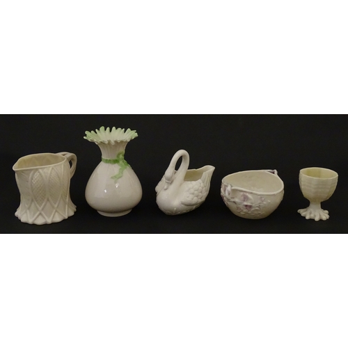 83 - Six assorted Belleek items comprising a cream jug in the Ampanida pattern, a small vase with bow det... 
