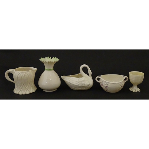 83 - Six assorted Belleek items comprising a cream jug in the Ampanida pattern, a small vase with bow det... 