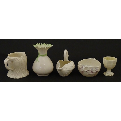83 - Six assorted Belleek items comprising a cream jug in the Ampanida pattern, a small vase with bow det... 