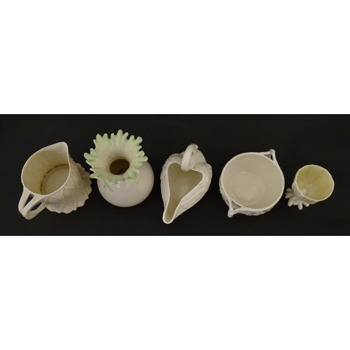 83 - Six assorted Belleek items comprising a cream jug in the Ampanida pattern, a small vase with bow det... 
