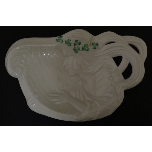 85 - A quantity of Belleek to include an Art Nouveau style butter dish with harpist lady and shamrock det... 