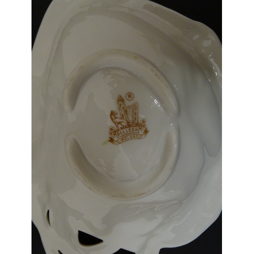 85 - A quantity of Belleek to include an Art Nouveau style butter dish with harpist lady and shamrock det... 