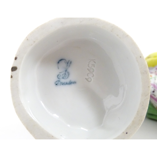 86 - Two Dresden figures comprising The Game Seller, and Lady with Flowers. Marked under. Approx. 6