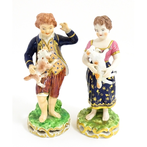 104 - A pair of Derby figures modelled as a boy holding a dog, and a girl holding a lamb. Marked under. Ap... 