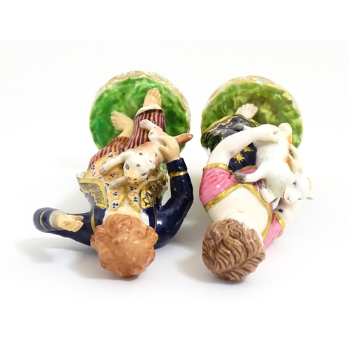 104 - A pair of Derby figures modelled as a boy holding a dog, and a girl holding a lamb. Marked under. Ap... 