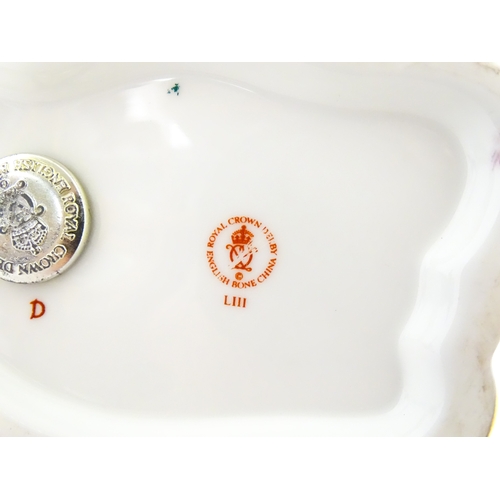 108 - A Royal Crown Derby paperweight modelled as a ram / sheep. Together with a Royal Crown Derby paperwe... 