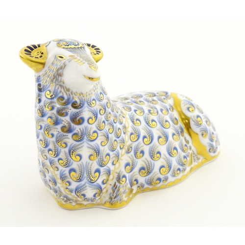 108 - A Royal Crown Derby paperweight modelled as a ram / sheep. Together with a Royal Crown Derby paperwe... 