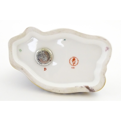 108 - A Royal Crown Derby paperweight modelled as a ram / sheep. Together with a Royal Crown Derby paperwe... 