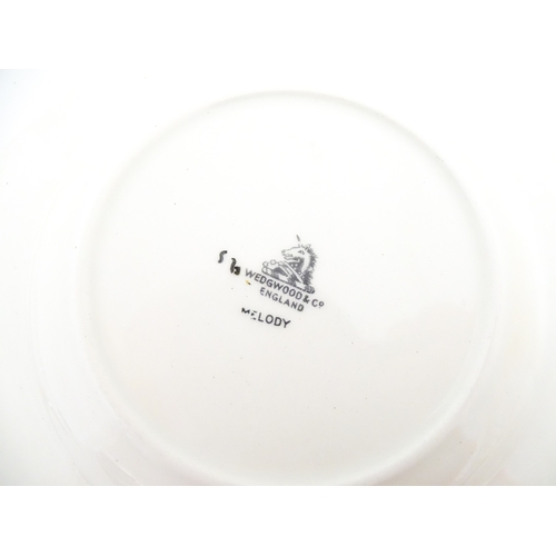 110 - A cased Wedgwood cake / sandwich service in the Melody pattern comprising serving plate, cake plates... 