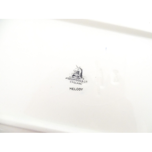 110 - A cased Wedgwood cake / sandwich service in the Melody pattern comprising serving plate, cake plates... 