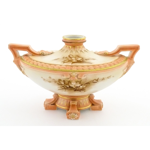 114 - A Hadley's Worcester twin handled squat vase of boat form with floral and foliate decoration. Marked... 