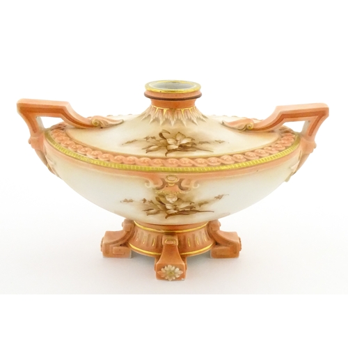 114 - A Hadley's Worcester twin handled squat vase of boat form with floral and foliate decoration. Marked... 